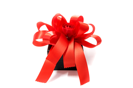 Gift box tied with a red bow on white background.の写真素材