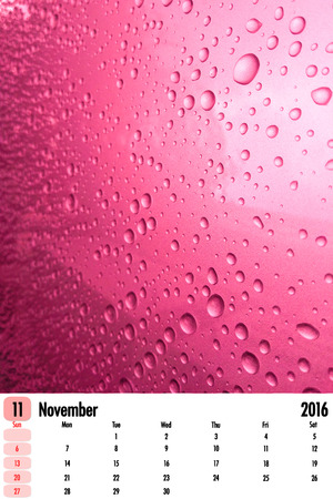 2016 calendar on rain drops color texture background.の写真素材