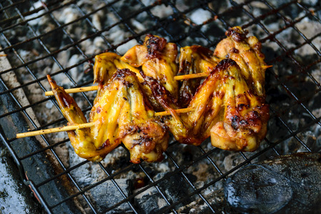 Grilled chicken on the stove in the market.の写真素材