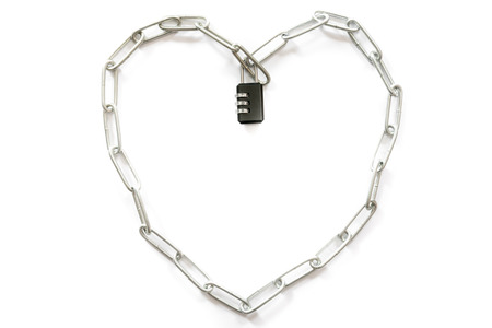 Heart-shaped steel strap with black keys on white background.の写真素材