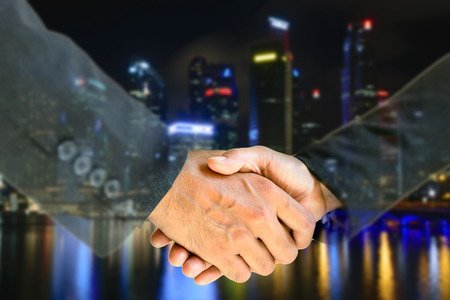 Business men and women shaking hands with each other to work together.の写真素材