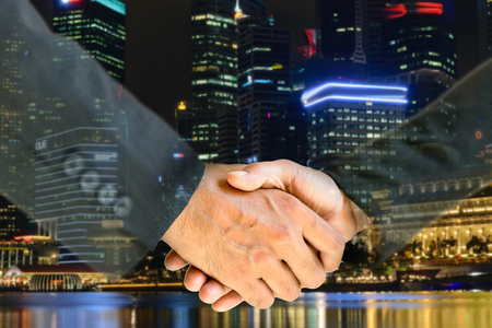 Business men and women shaking hands with each other to work together.の写真素材
