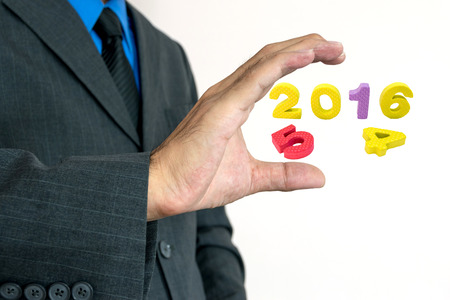 Young businessman holding a words greeting Happy New Year.の写真素材