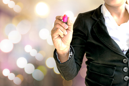 Bussiness woman  writing the word about business.の写真素材