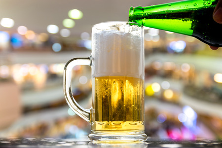 Beer golden white bubbles in the glass on beautiful background for Christmas and new year days.の写真素材