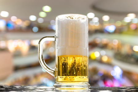 Beer golden white bubbles in the glass on beautiful background for Christmas and new year days.の写真素材