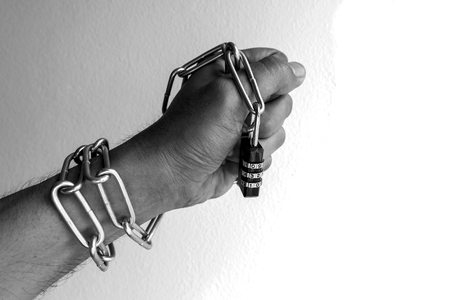 The chain lock was at the hands of men.の写真素材