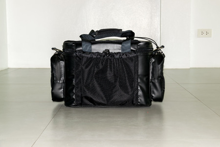 Black leather multi-pocket for camera equipment and tools.の写真素材