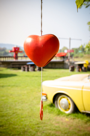 Heart-shaped bell hanging on the tree for Valentine's Day.の写真素材