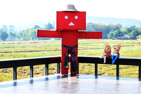 Scarecrow on the terrace with the backdrop of the field.の写真素材