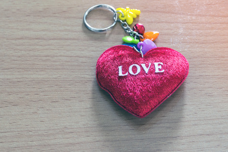 Red heart shaped on wooden background sign for love and valentine days.