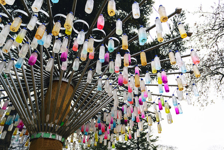 Plastic bottles are recycled to make useful ornament on the tree.の写真素材