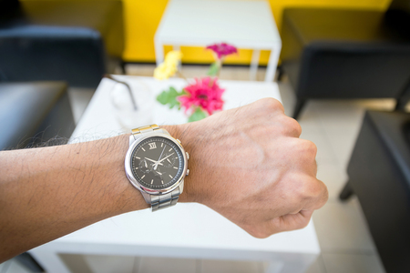 Businessman looking at his wristwatch, it was time to work yet.の写真素材