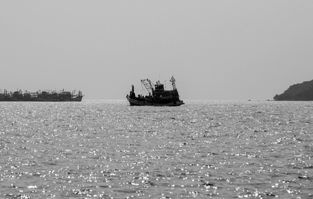 Fishing boats floating in the sea.の写真素材