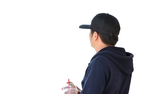 Back view of young man wearing a black cap and long sleeve blue, isolated over white background.の写真素材