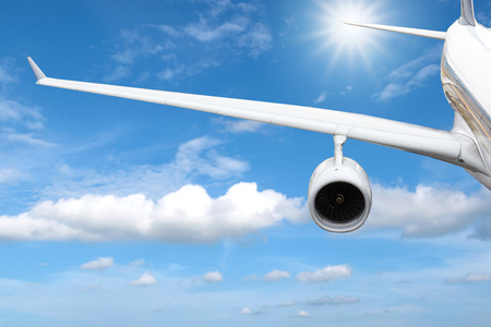 View of airplane wings while flying over beautiful blue sky.の写真素材