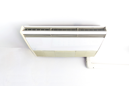 Air conditioning hung on the ceiling in the white room.の写真素材