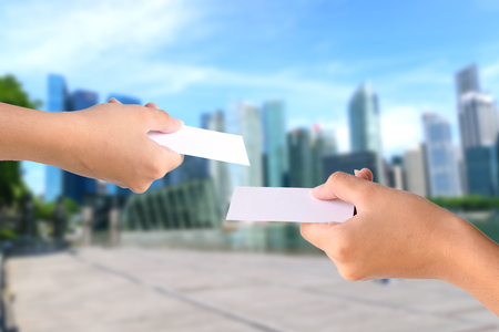 Hand holding empty white paper isolated on white background.の写真素材