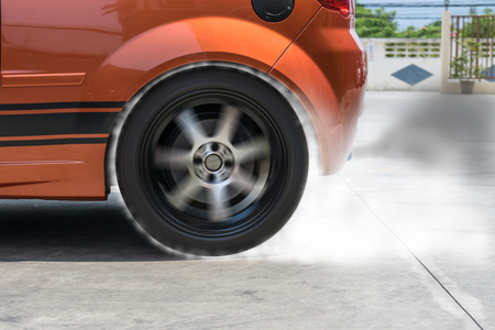 The smoke caused by the friction of tires on the road surface when the wheel rotational speeds.の写真素材