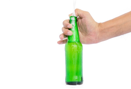 Hand holding the glass bottles for beer, alcohol or other beverage industry isolated on white background.の写真素材