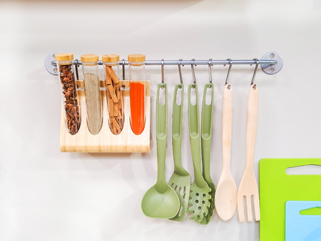 Modern design of the kitchen tools hanging on wall in the kitchen room.