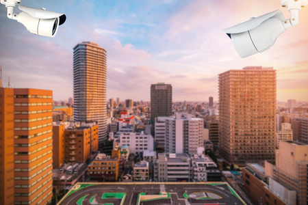 CCTV or surveillance camera  recording  important events and a guard house and property with the sunrise in the morning at the big city background.の写真素材
