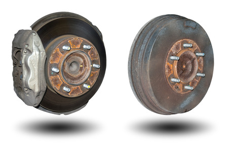 Old rusty disc brakes front wheel and back drum brakes of the car isolated on white background.の写真素材