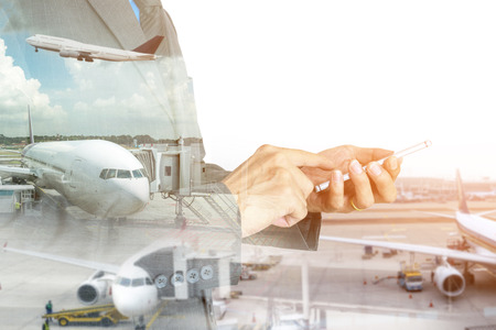 Double exposure of businessman using smart phone on the airport runway background.の写真素材