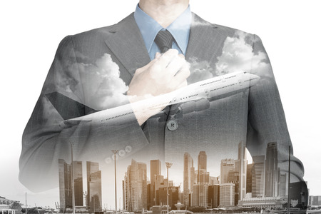 Double exposure of businessman in suit on city with airplane background.の写真素材