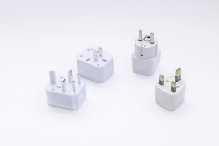 Group of universal plugs adapters isolated on white background.の写真素材