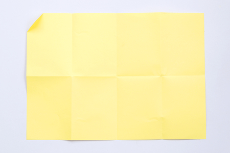 Closeup of creased paper isolated on white background.の写真素材