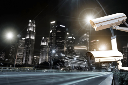 Closeup of traffic security camera surveillance (CCTV) on the road in the night city.の写真素材