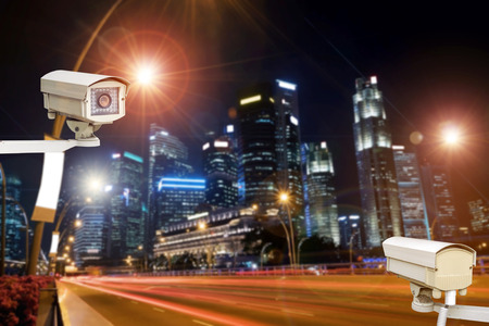 Closeup of traffic security camera surveillance (CCTV) on the road in the night city.の写真素材