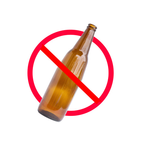The red circle with slash on the glass bottle of alcohol on white background; concept for stop drinking.の写真素材