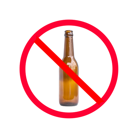 The red circle with slash on the glass bottle of alcohol on white background; concept for stop drinking.の写真素材