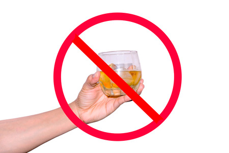 The red circle with slash on woman's hand holding a glass of wine with ices on white background; concept for stop drinking.の写真素材