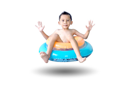 Cute Asian boy sitting on the colorful swim rings isolated on white background.の写真素材