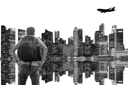 Backpacker standing and looking at to the skyscraper of the city; Black and white filter tone.の写真素材
