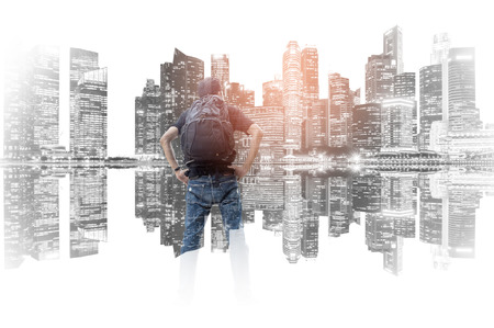 Double exposure of backpacker on the skyscraper background.の写真素材