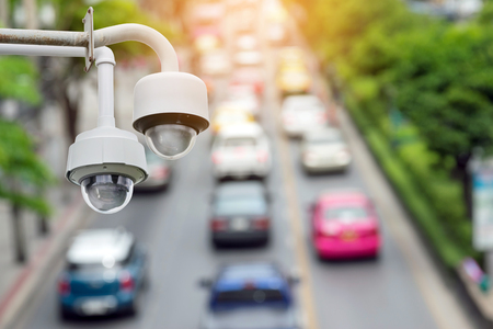 Closeup of traffic security camera surveillance (CCTV) on the road in the big city.の写真素材
