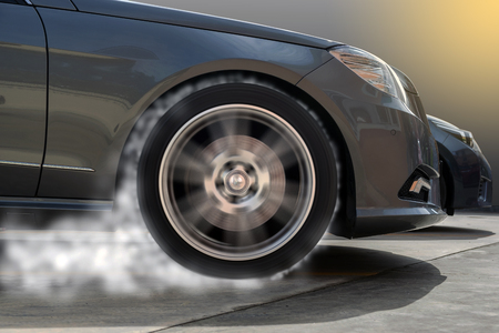 Closeup of the front wheels that spin and cause smoke.の写真素材
