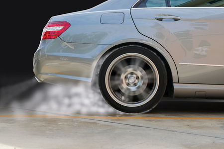 Closeup of the rear wheel of a car that spin and cause smoke.の写真素材
