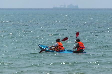 Chon Buri,Thailand-Feb 21,2016:Travelers man and woman canoeing on the sea and enjoy the holiday.のeditorial素材