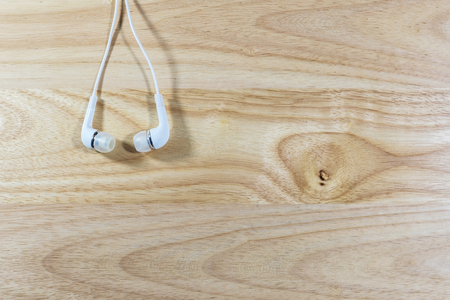Headphone or earphone  on wooden background.の写真素材