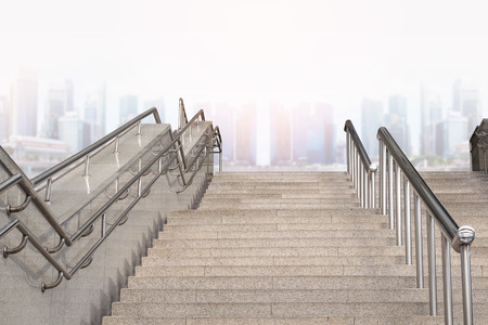 Marble staircase railing stainless steel with the skyscrapers background.
