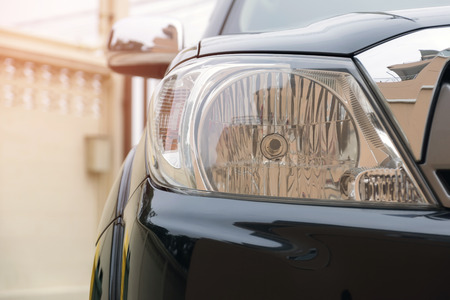 Closeup of car headlight lamp with beautiful sunlight.の写真素材