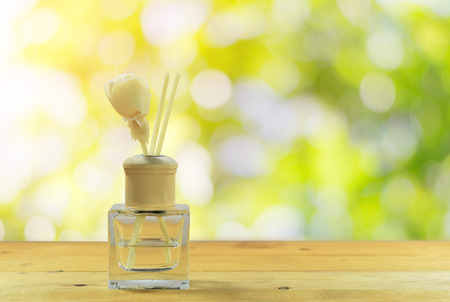 Bottle-conditioned on the wooden floor with the beautiful green nature background.の写真素材