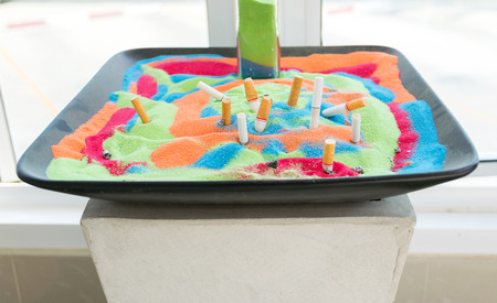 Smoked cigarettes in the sand beautiful colors  in the ashtray.の写真素材