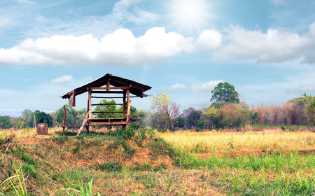 Vintage wooden cottage in the farm with beautiful sunlight and cloudsky.の写真素材