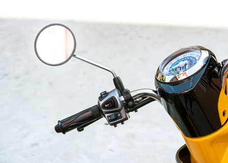 Closeup to handle,speedometer and rear view mirror of the motorcycle.の写真素材
